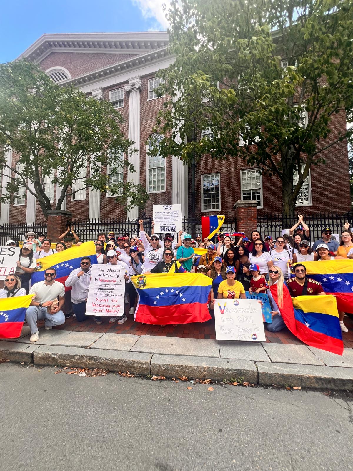 Venezuelan community rally with flags outside a historic building